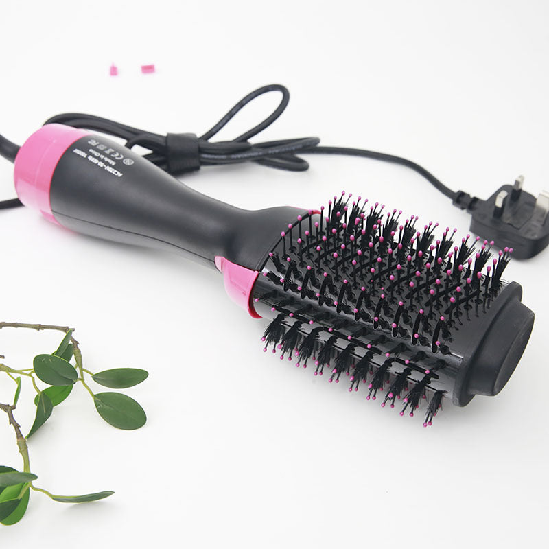 Hair styling tool with pink and black design on a white background